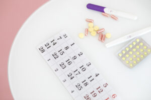 a calendar with pills and a pregnancy test